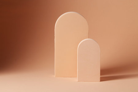 Two wooden arch on a beige background, element for design with copy space for text or image
