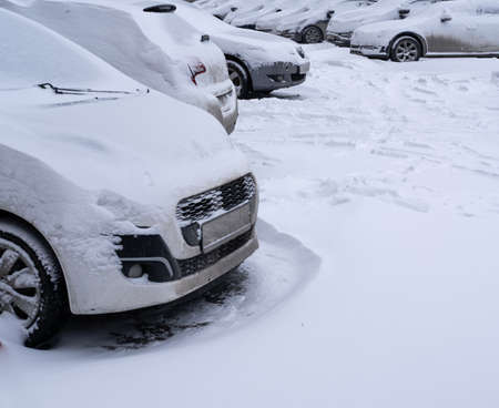 cars covered with snow after heavy snowfallの写真素材