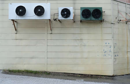 a strong stream of water pours from the air conditioner from the heatの写真素材