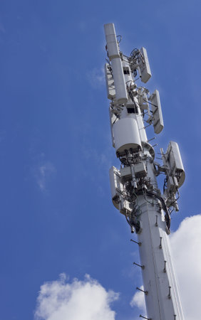 A cell tower with a blue sky background の写真素材