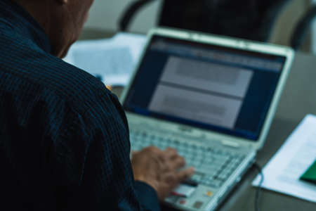 lawyer working in an office with a computer while reading, office worker concept.の写真素材