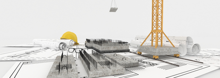 Foundation under construction with crane, on top of blueprintsの写真素材