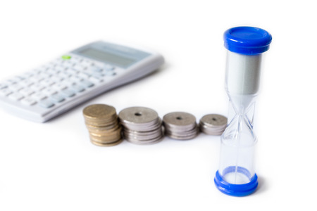 Stack of money with calculator and hourglass isolated on white background. Danish krone. can be used for economic and money themesの写真素材