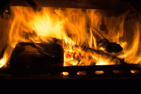 fire in fireplace with burning tree. warm and hot fire can be used for winter themesの写真素材