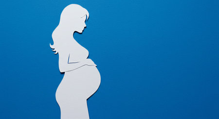 Pregnant woman silhouette on a blue background. Copy space.の素材