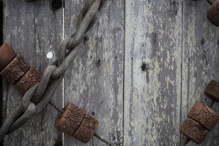 Old, grungy, antique, vintage fishing equipment on a wood background.  Includes rope and floatsの写真素材