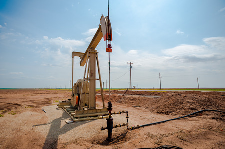 A single oil pumpjack on the plains of west Texas on a sunny day.の写真素材