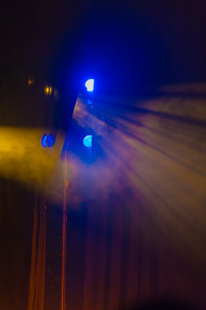 A stage light background with fog and beams of lightの写真素材