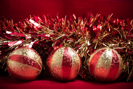 Red and Gold Christmas decorations on a red backgroundの写真素材