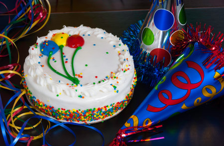 A birthday cake and party hatsの写真素材