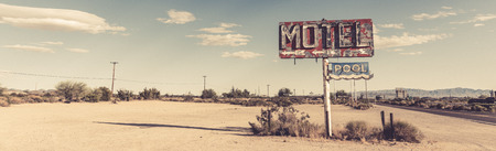 A dilapidated, classic, vintage motel sign in the desert of Arizonaの写真素材