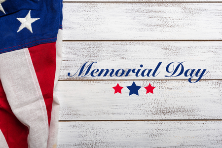 United states flag on white, weathered clapboard background with memorial day greetingの写真素材