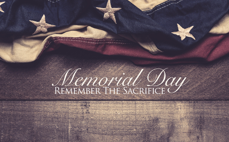 A vintage American flag or bunting on a wooden background with memorial day greetingの写真素材