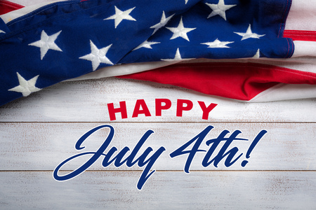 United states flag on white, weathered clapboard background with july 4th greetingの写真素材