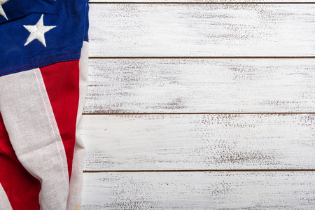 United states flag on white, weathered clapboard background with copy spaceの写真素材