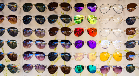 A colorful group of sunshades on sell at a marketの写真素材