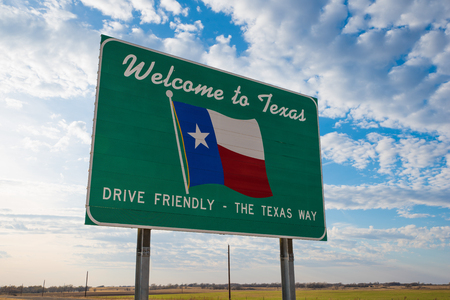 Welcome to Texas road sign in front of cloudy skyの写真素材