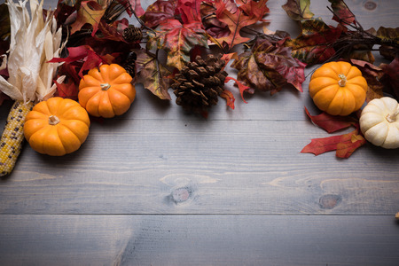 Fall, autumn pumpkins, leaves and veggies on a wooden background. Thanksgiving theme.の写真素材