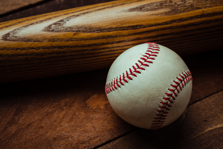 A group of vintage baseball equipment, bat, baseball on wooden backgroundの写真素材