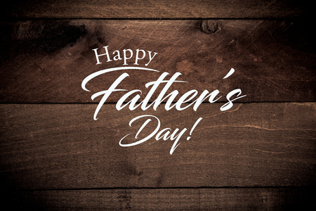 A wooden background with a fathers day greetingの写真素材