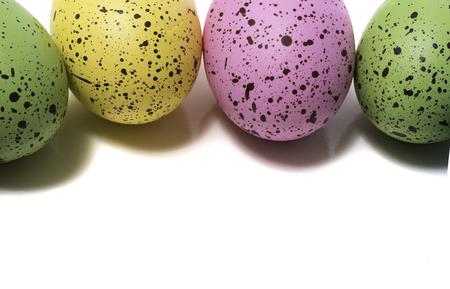 A group of colorful Easter eggs on a white backgroundの写真素材
