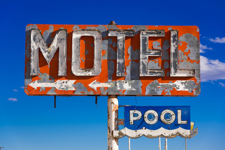 A dilapidated, classic, vintage motel sign in the desert of Arizonaの写真素材