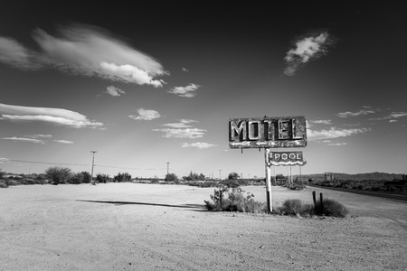 A dilapidated, classic, vintage motel sign in the desert of Arizonaの写真素材
