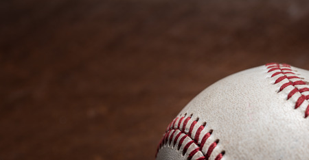 A group of vintage baseball equipment, bats, gloves, baseballs on wooden backgroundの写真素材