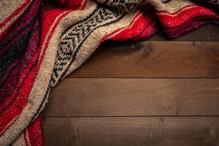 A mexican serape blanket on a wooden plank backgroundの写真素材
