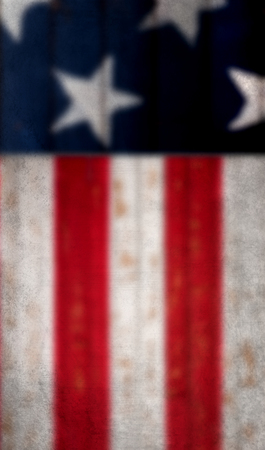 A blurred, grungy, American flag background. The stars and stripesの写真素材
