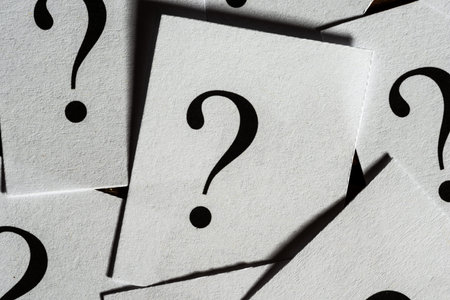 A group of printed question marks on paper