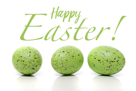A group of green Easter Eggs with speckles on a white backgroundの写真素材