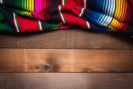 A mexican serape blanket on a wooden plank backgroundの写真素材