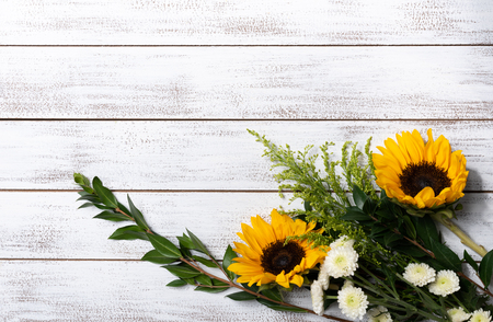 A Yellow sunflower arrangement on white wood background with copy spaceの写真素材