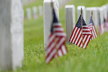 Small American flags and headstones at National cemetary- Memorial Day displayの写真素材