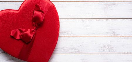 Valentines day gift box on a white wooden background with copy spaceの写真素材