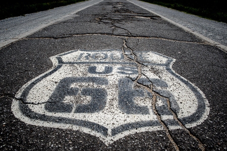 The famous route 66 highway shield painted on ta histroic stretch of single lane highway dating from the 1920sの写真素材