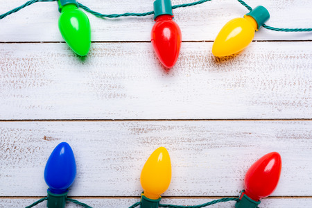 A group of colorful christmas lights on a white background with copy spaceの写真素材