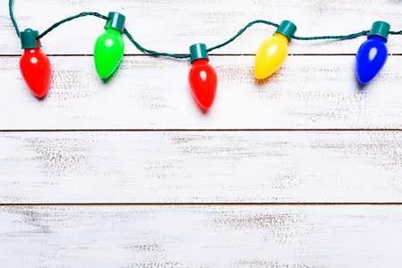 A group of colorful christmas lights on a white background with copy spaceの写真素材