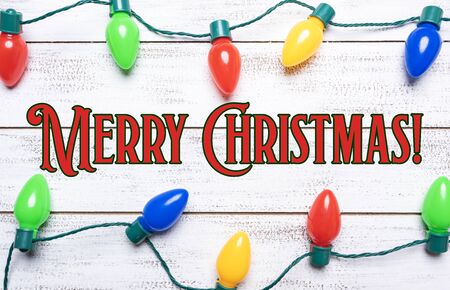 A group of colorful christmas lights on a white background with copy spaceの写真素材