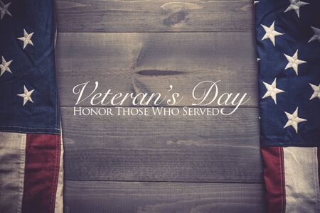 The flag of the United Sates of America on a grey plank background with Veterans Day greetingの写真素材