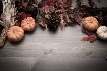 Fall, autumn pumpkins, leaves and veggies on a wooden background. Thanksgiving theme.の写真素材