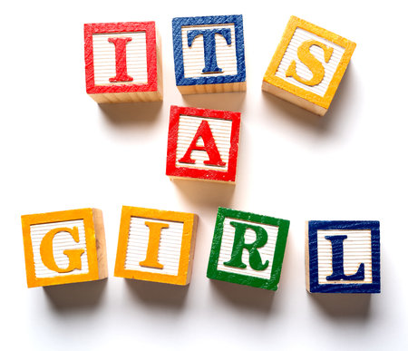 Children blocks spelling out its a girl. Birth or gender announcementの写真素材
