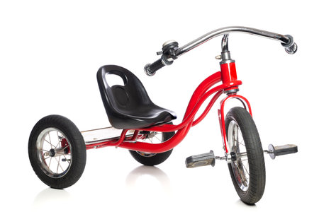 Childrens tricycle on a white backgroundの写真素材