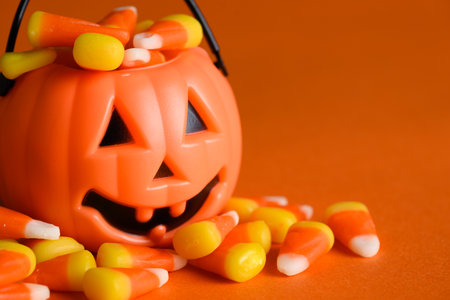 Jack-o-lantern halloween bucket with candy cornの写真素材