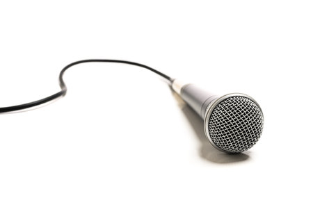 A vocal microphone on a white background with cordの写真素材