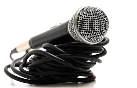 A vocal microphone on a white background with cordの写真素材