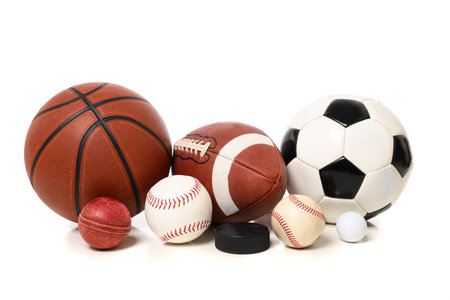 A group of sports balls including cricket, baseball, softball, football, soccer, basketball, golf, and hockeyの写真素材