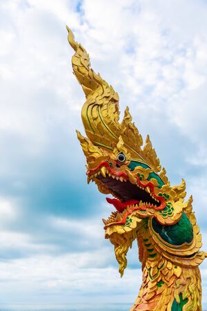 snakes in Buddhism are sacred animals, their other name is naga, reptiles guard the entrance to the temple, made of concrete and paintsの写真素材