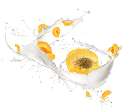 Apricots in milk splash, isolated on white backgroundの写真素材